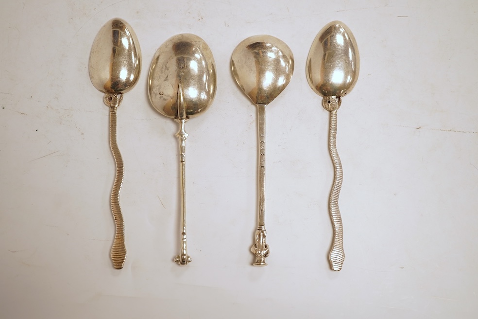 An 18th century silver apostle spoon, indistinct marks, 17cm, a continental white metal spoon with scroll handle and a pair of unmarked white metal spoons with serpent handles.